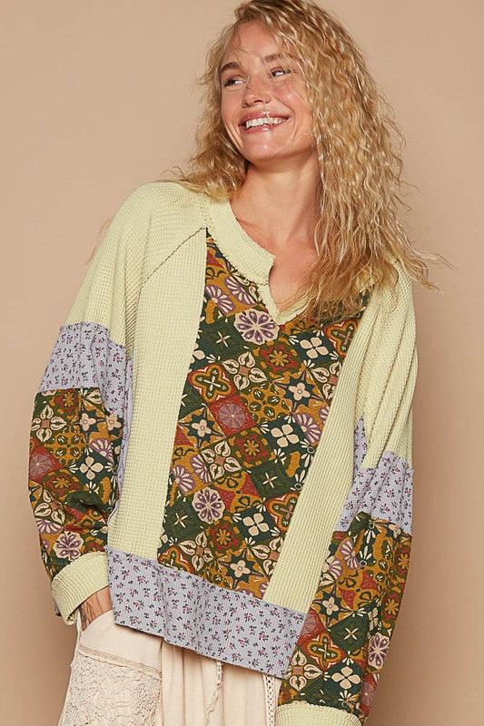 Exposed Seam Printed Notched Raglan Sleeve Knit Top